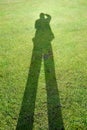 Shadow of a man on background of green grass illustrates the concept of a photographer Royalty Free Stock Photo