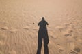 Shadow of man on beach taking photo Royalty Free Stock Photo