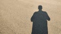 Shadow of a man on empty road in daylight symbolizing solitude journey identity and reflection in minimal urban scene Royalty Free Stock Photo
