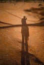 Shadow of man on ground in red desert dunes Royalty Free Stock Photo