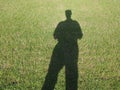 man shadow over green meadow Royalty Free Stock Photo