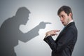 Shadow of man is pointing and blaming businessman. Conscience concept. Royalty Free Stock Photo