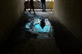 The shadow of a man in a puddle in an old apartment