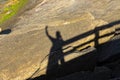 Shadow man with raised arm. Silhouette of Man Celebration Success Happiness on a stone sunset Background.