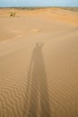 Shadow from a man on a sand dune in the desert. Royalty Free Stock Photo