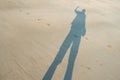 Shadow of the man on the sandy beach Royalty Free Stock Photo