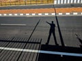 the shadow of a man showing route on a road Royalty Free Stock Photo