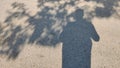 Shadow of man and tree on ground in daylight symbolizing human connection with nature solitude and peaceful reflection Royalty Free Stock Photo