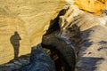 The shadow of a man on a wall of yellow sandstone. Royalty Free Stock Photo