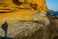 The shadow of a man on a wall of yellow sandstone. Royalty Free Stock Photo