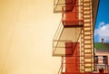 Shadow Of Metal Fire Escape On The Wall Of Old Yellow House Royalty Free Stock Photo