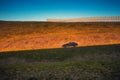 Shadow of a moving car on mountain at sunset Royalty Free Stock Photo