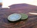 Shadow over euro coins, euro cents and 2 euro. Royalty Free Stock Photo