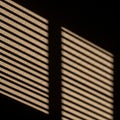 Shadow pattern on a textured surface, created by sunlight filtering Royalty Free Stock Photo