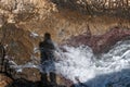 Shadow of a person projected on a background of rock and waves Royalty Free Stock Photo