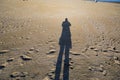 Shadow of person on yellow sand on beach Royalty Free Stock Photo