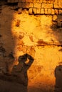Shadow of a photographer on earthen wall of ancient chinese house at dusk, Chengzi Village, Yunnan, China Royalty Free Stock Photo