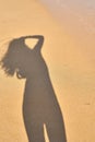 Shadow from the photographer girl in the sand, silhouette in the sand