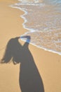 Shadow from the photographer girl in the sand, silhouette in the sand