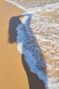 Shadow from the photographer girl in the sand, silhouette in the sand, wave