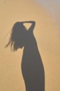 Shadow from the photographer girl in the sand, silhouette in the sand,