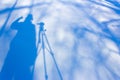 Shadow photographer with a tripod in the snow