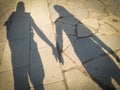 Shadow of a pilgrim couple holding hands