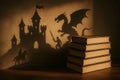 Shadow Play: A Knight, Dragon, and Castle Silhouette Projected onto Books Royalty Free Stock Photo