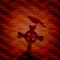 Shadow of raven and cross on a brick wall Royalty Free Stock Photo