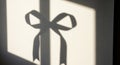 A shadow resembling a bow is projected on a white wall, likely formed by light and an object out of Royalty Free Stock Photo