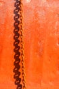 Shadow of a rusty metal chain on on a rusty steel surface, reddish background