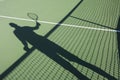 Shadow of senior man playing tennis on court Royalty Free Stock Photo