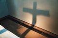 Shadow silhouette of Jesus Christ on the cross projected on wall. Play of light and shadows. Faith, Christianity and Royalty Free Stock Photo