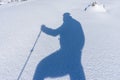 Shadow silhouette of a mountaineer on snow