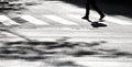 Shadow silhouette of a person crossing the street