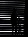 Shadow silhouette of a person pushing a bike on outdoor stairs in the night