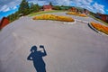 The shadow of the silhouette of the photographer on the pavement in a country village, photographed himself on the lens fisheye Royalty Free Stock Photo