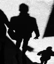 Shadow silhouette of unrecognizable people walking city street