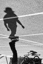 Shadow of a skateboarder and bicycler on asphalt. Black and whit