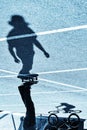 Shadow of a skateboarder and bicycler on asphalt. Blue toning Royalty Free Stock Photo