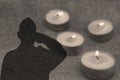 Shadow of a soldier Soldier Israel IDF with salutes on grey background with burning funeral candles. Image for Memorial day Royalty Free Stock Photo