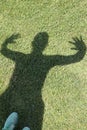 Shadow of a sporty woman on the meadow of a park Royalty Free Stock Photo