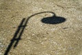 Shadow of street lamp in sunny day, road lantern in park