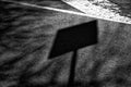 Shadow street sign on asphalt road, urban background