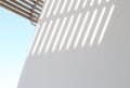 Shadow from the striped lattice on a white wall Royalty Free Stock Photo