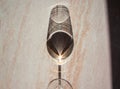 The shadow on the table from a glass of white wine like an alien face. Concept