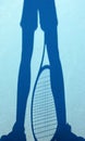 Shadow of a tennis player on a blue court