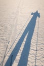 The shadow of a tour skier. Going cross country skiing. Royalty Free Stock Photo