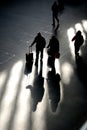 Shadow travellers on station concourse Royalty Free Stock Photo