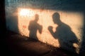 Shadow of two boxers training projected on a grunge wall at sunset Royalty Free Stock Photo